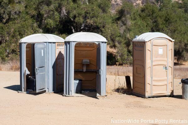 a clean row of portable restrooms for outdoor weddings or festivals in Horatio, AR